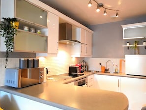 Kitchen equipped with hob, oven, microwave, coffee machine, fridge, freezer etc.