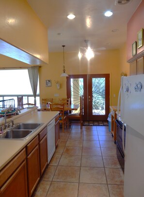 kitchen area looking out of French doors to covered patio