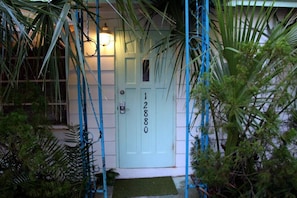 Keypad front door lock. Turquoise door hints at the midcentury interior decor!