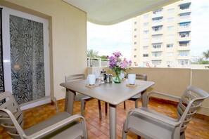 Outdoor dining area for four guests with views to the pool