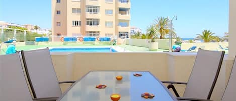 Outdoor dining area for four guests on the terrace with views to the pool