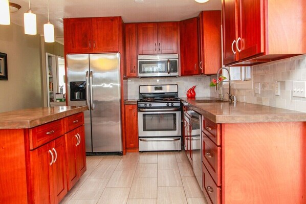 Full kitchen for you to enjoy a meal or two. Gas range, rice cooker, cooking utensils and dishes provided.
