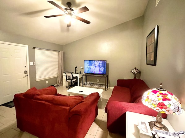 High ceiling living area with work desk