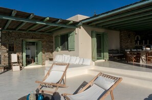View of upper terrace with living room on the left and outdoor dining area right