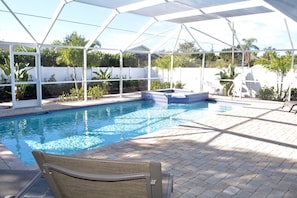 Fenced and screened in heated pool and spa