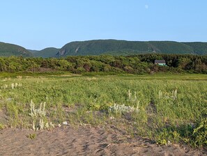The Cottage on Sunset Lane, seated at the foot of the Cape Breton Highlands.