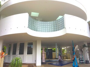 Aerialist practice yoga in the lanai area. Unique beautiful architecture.
