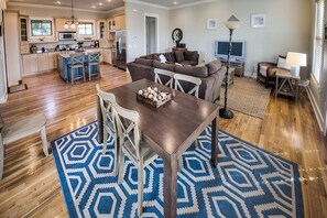 Dining Table, Chairs, Sofa, TV, and Ceiling Fans.