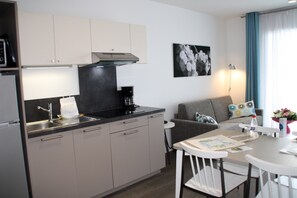 Prepare meals in the kitchenette and enjoy them at the dining table.