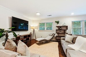 Living room area with 75 inch Flat Screen Smart TV