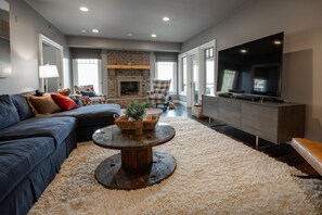 Family room, lower level, ample seating and a huge TV.
