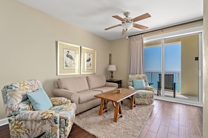 Living area with plenty of seating and a ceiling fan