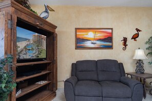 Large TV center and recliner in the living room.