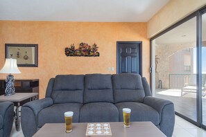Large sofa and patio with view.,