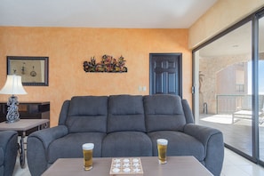 Large sofa and patio with view.,