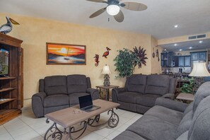 The living room has ample space and lots of comfy seating.