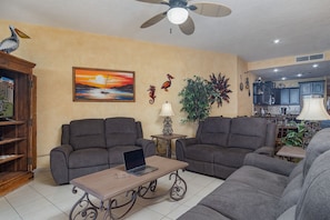 The living room has ample space and lots of comfy seating.