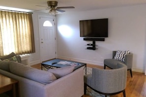 Relax in this comfortable living room with a 55 inch HDTV and Bose Soundbar.