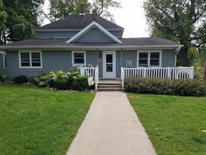 Front of the house.  3 steps into the house.