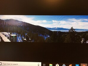 View from roof which includes hot tub, sauna, Bbq grills and tables