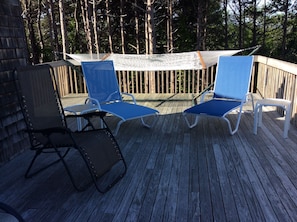 Large deck with plenty of furniture. It faces west for afternoon sun and sunsets