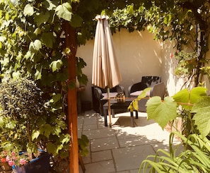 the private a shaded terrace surrounded by old vines