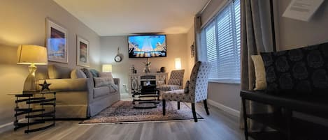 Spacious living room with a queen size pull out sofa bed and fireplace. 