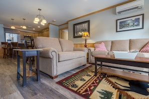 The living room has a sofa and love seat, flat-screen cable TV and gas fireplace