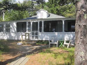 Front view. Screened porch entrance. Two bdrm windows on left. 