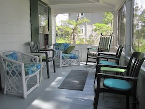 the screened porch at the front of the house with ocean views.