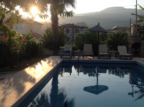 Pool and garden at sunset.