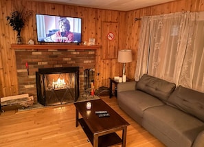 Livingroom area with 43 inch tv, real wood fireplace & fake fireplace available