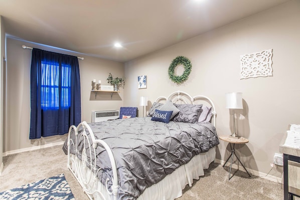 New queen bed with nightstands and lamps on both sides
