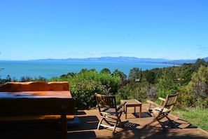 View across Golden Bay from Sundeck - two tables for dining and large BBQ 