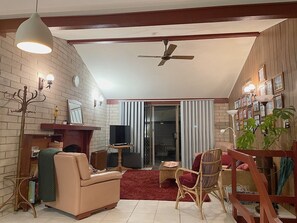 Living room has a wood heater and fan