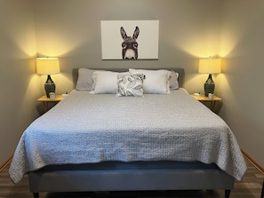 King bed in master. Bedside lamps and charging stations on both sides.