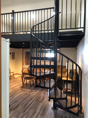 Spiral stair to sleeping loft. Ceiling is less than 4 ft high. Please watch head