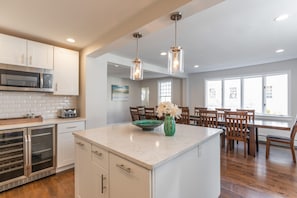 Gourmet kitchen with access to the large dining table seating 18 or more. 