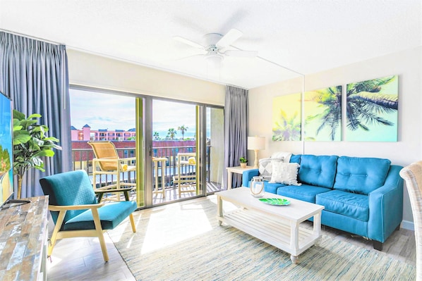 Relax in this cozy beachside condo with a plush sofa and a 65-inch tv