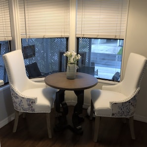 Cozy table and chairs by windows for two