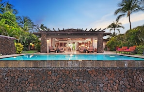 Your home away from home offers an infinity pool with exterior built lava rock wall.