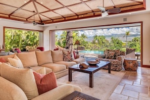 The bright and airy open living area features a plush sectional sofa.