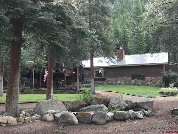 Creekside, privately set on a gentle slope among the evergreens w/fishing!