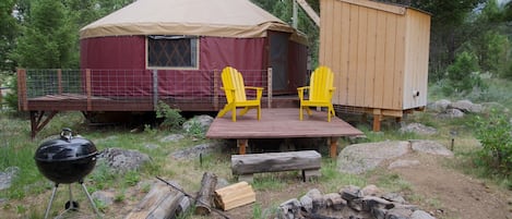 exterior of The Yurt, fire-pit, grilling/sitting area