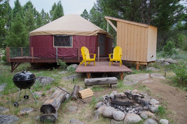 exterior of The Yurt, fire-pit, grilling/sitting area