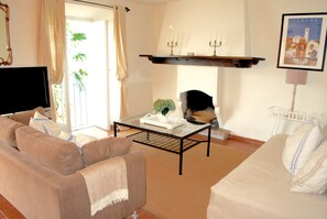 Living room with lakefront views and working fireplace