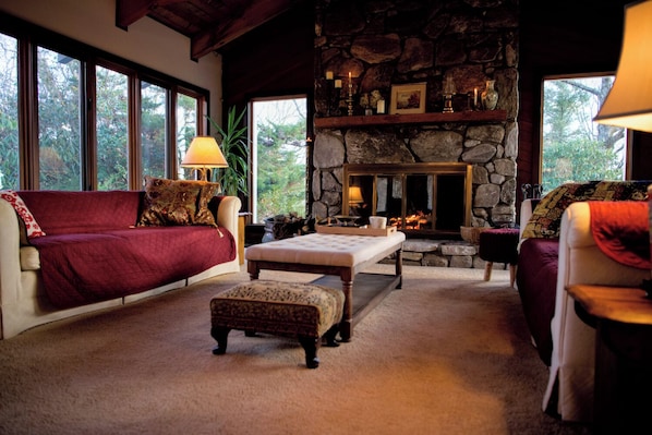 Main living room with wood burning fireplace.