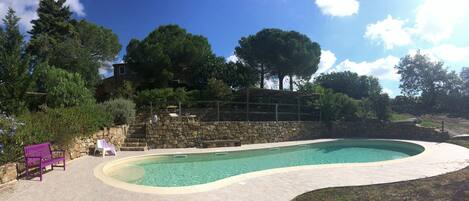 General view of swimming pool area and at the top the casale