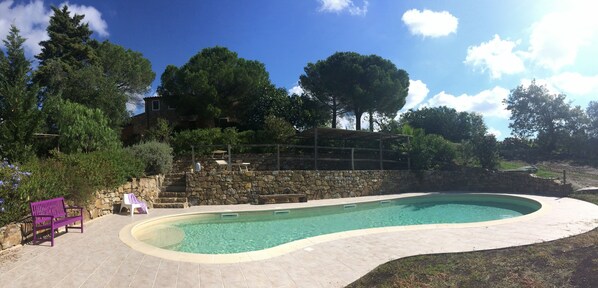 General view of swimming pool area and at the top the casale