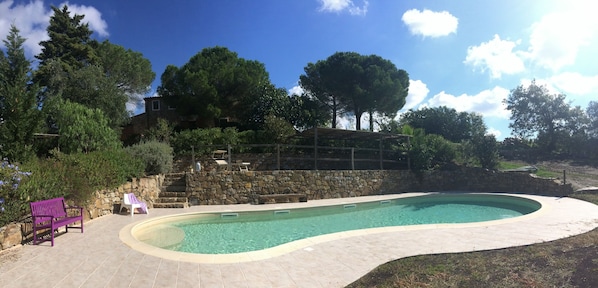 General view of swimming pool area and at the top the casale